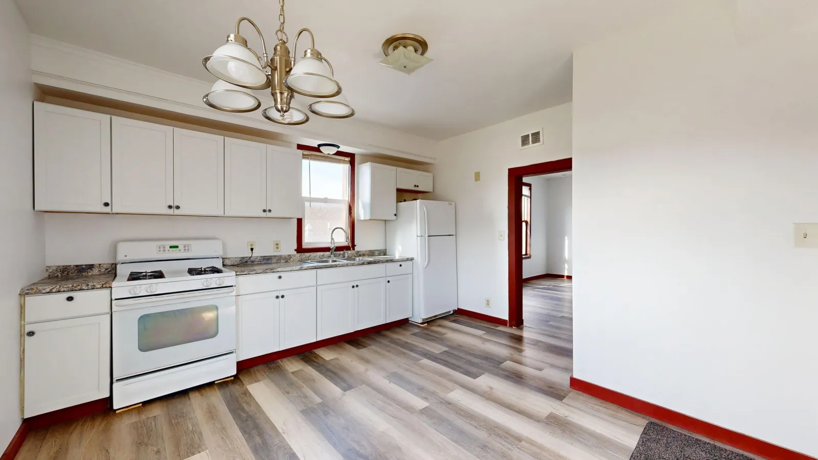 Laminate flooring paired with white kitchen cabinets