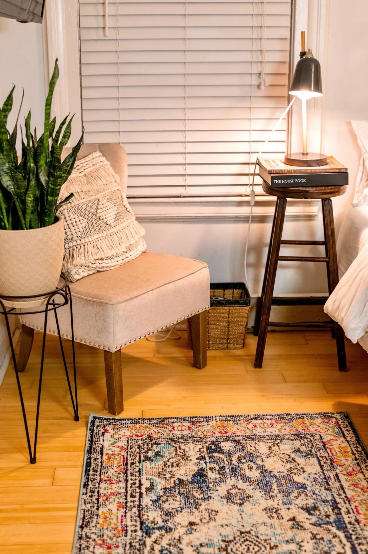 Wood-look luxury vinyl plank flooring in a warm, furnished bedroom