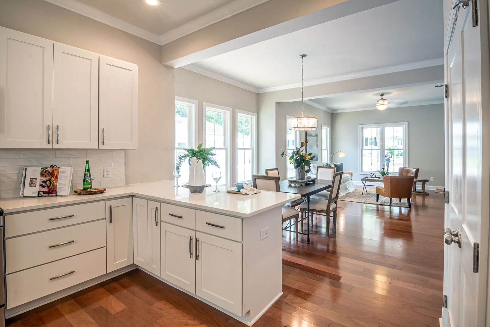 Open-concept DMV kitchen and living area with wood flooring