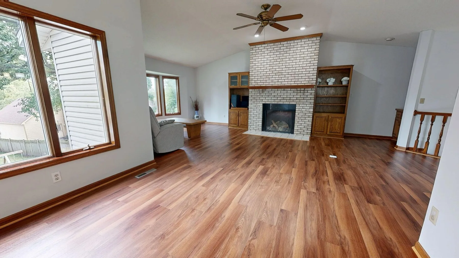Stained hardwood flooring in a furnished family room