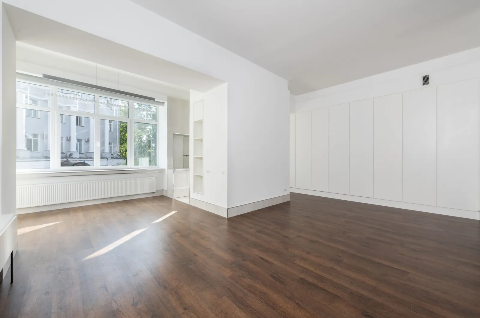 Vinyl plank flooring in a bright room with large windows